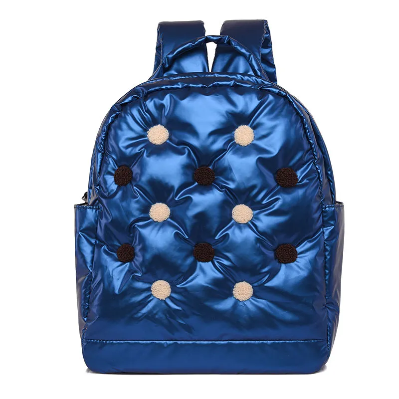 Blue quilted nylon backpack with beige and brown pom poms - vibrant fashion choice