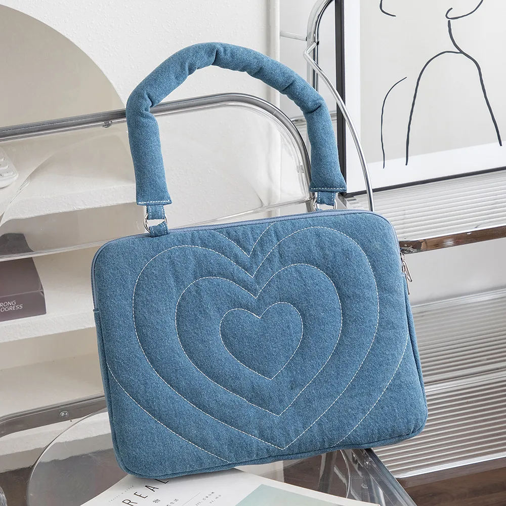 Denim heart butterfly apple embroidery panel detail on MacBook sleeve