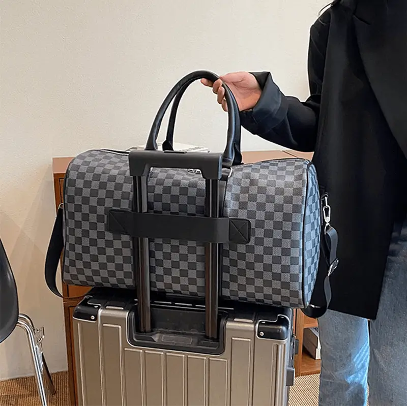 Leather bag factory - Luggage strap design showing innovative attachment feature for wholesale orders