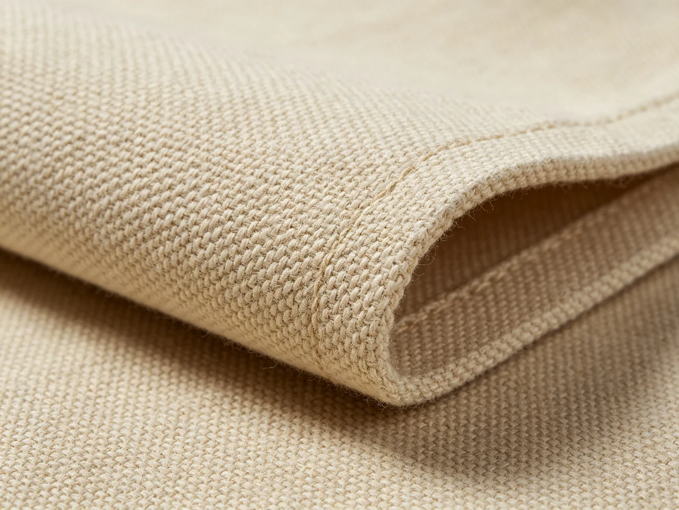 Natural beige heavy cotton canvas fabric texture showing thick coarse weave
