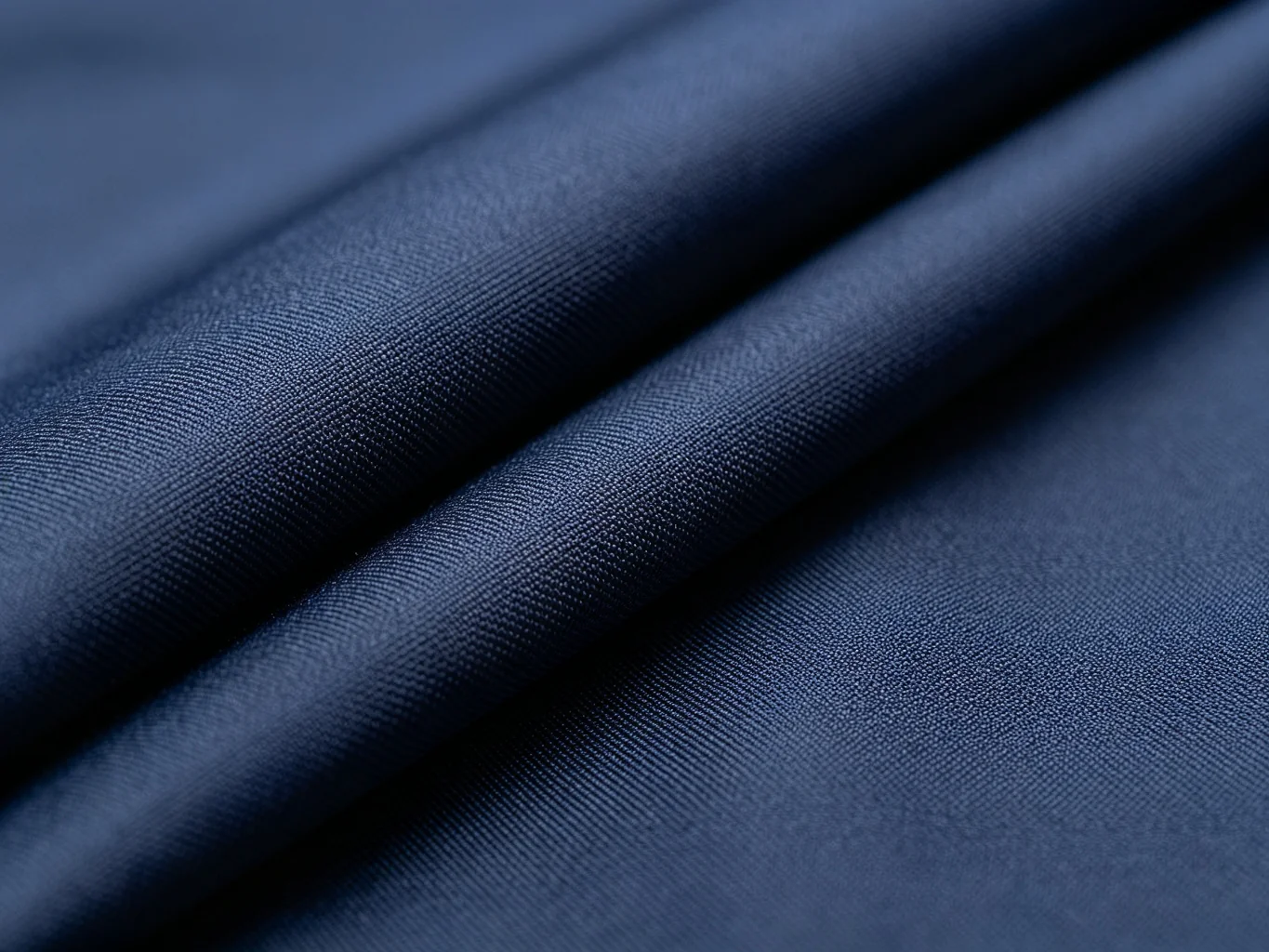 Dark navy nylon fabric texture close-up showing tight diagonal weave pattern