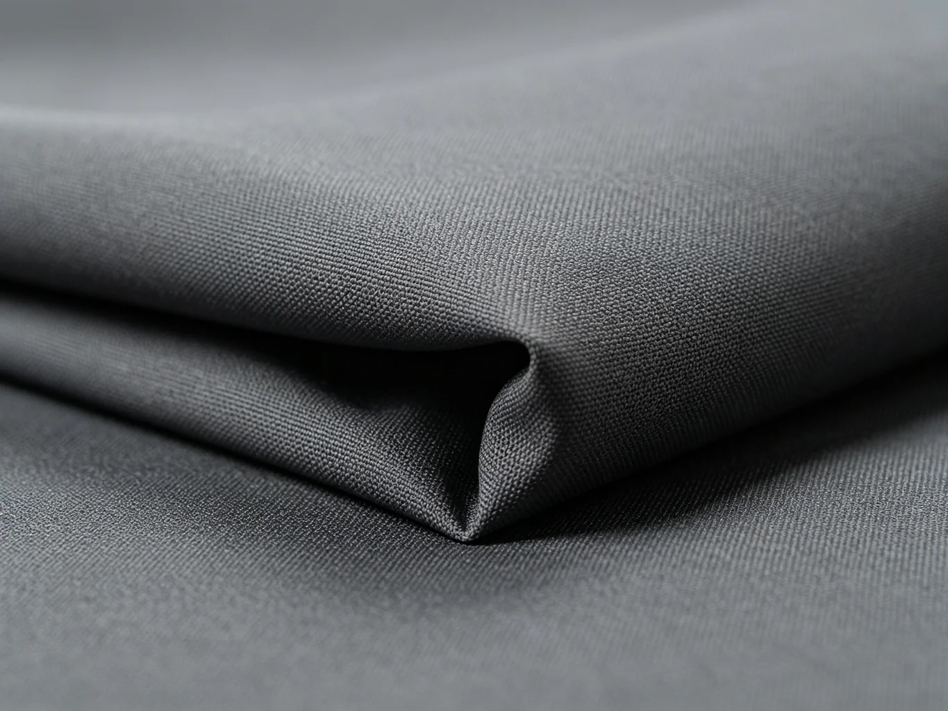 Charcoal gray 600D polyester fabric texture showing uniform tight weave