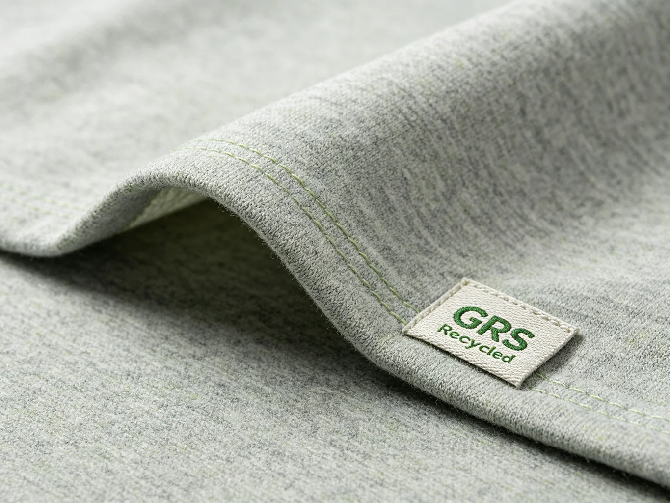 Light gray heathered recycled RPET polyester fabric with GRS recycled label tag