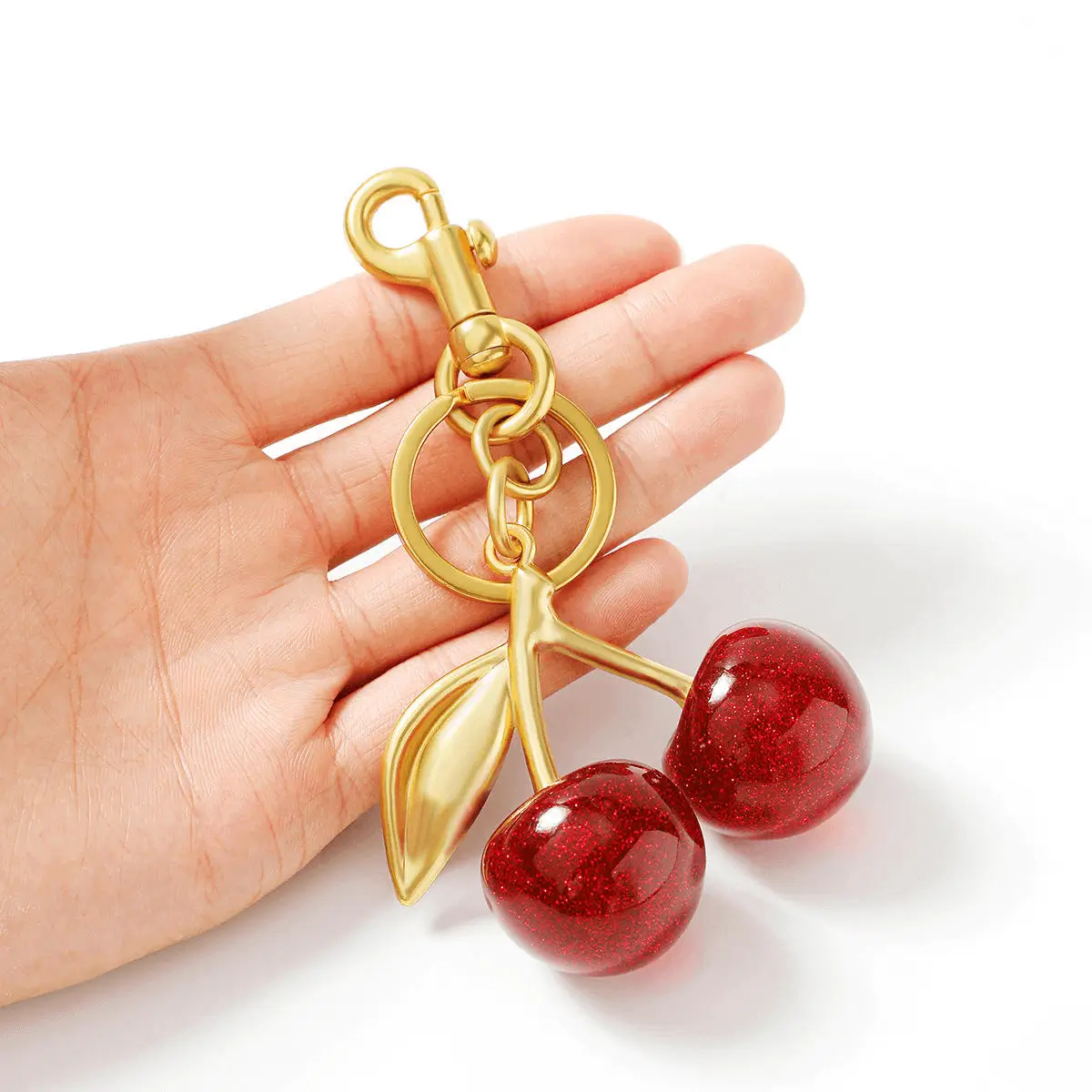 Cherry keychain in hand - Sparkling red cherry design for accessory factory production