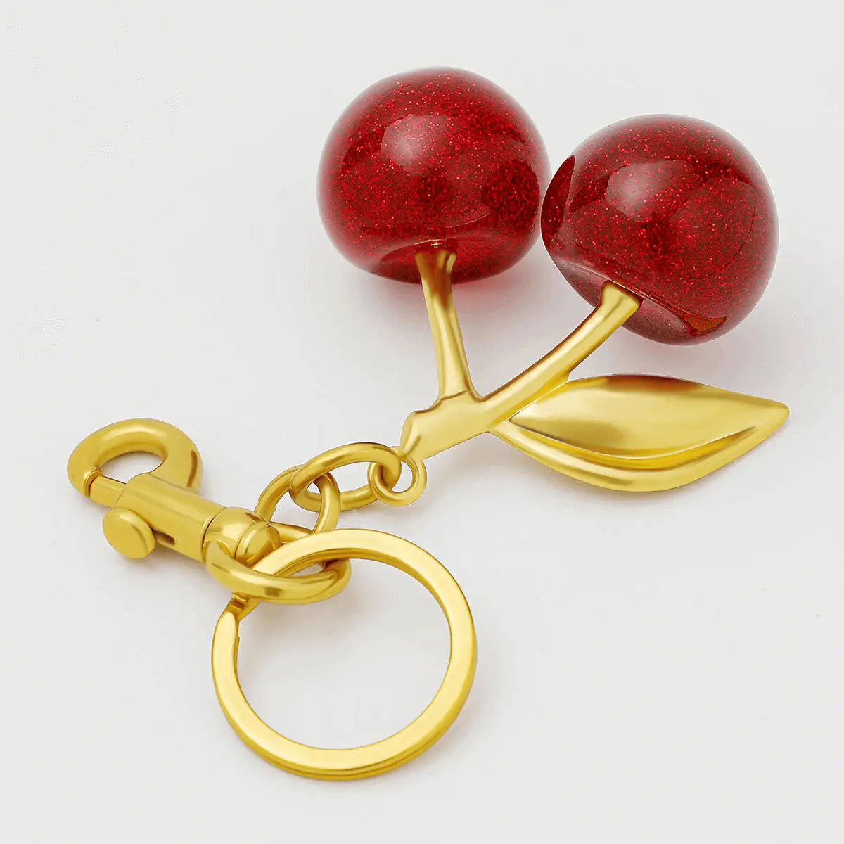 Close-up cherry keychain detail - Crystal details and golden hardware for wholesale showing premium craftsmanship