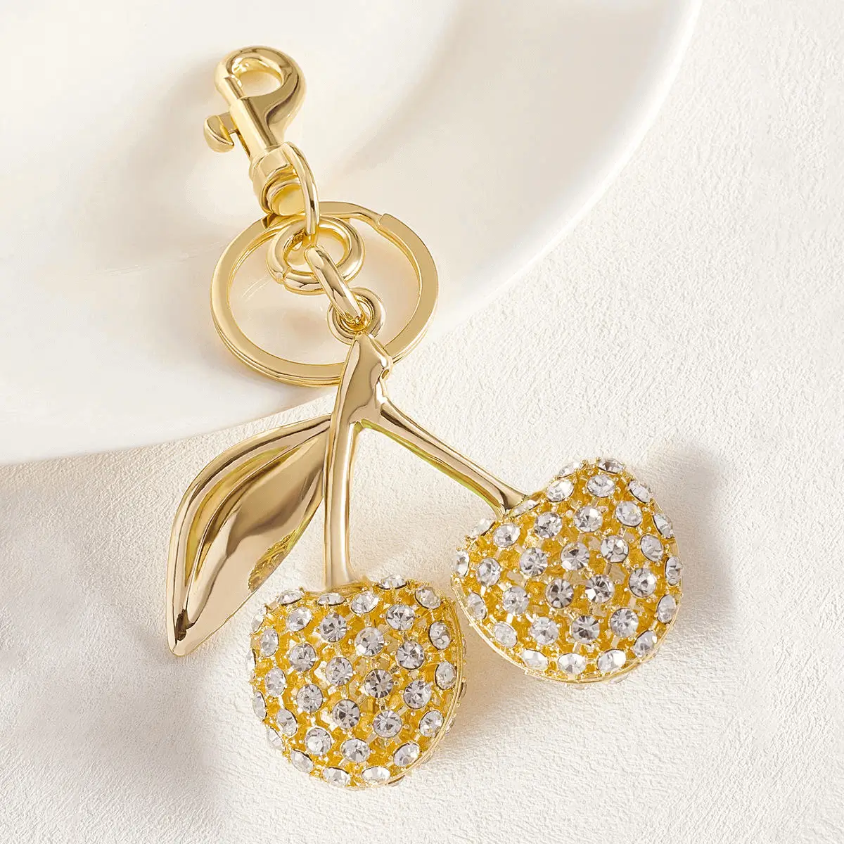Golden crystal cherry keychain - Luxurious accessory for wholesale distribution showing sophisticated appeal