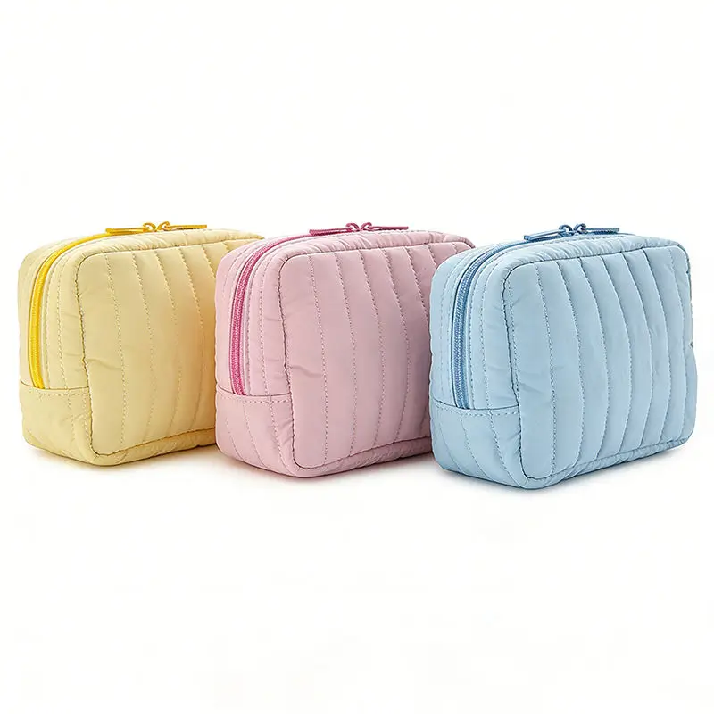 Quilted cosmetic bag manufacturer - Sunny yellow pastel quilted makeup bag with vertical stitching for custom OEM production