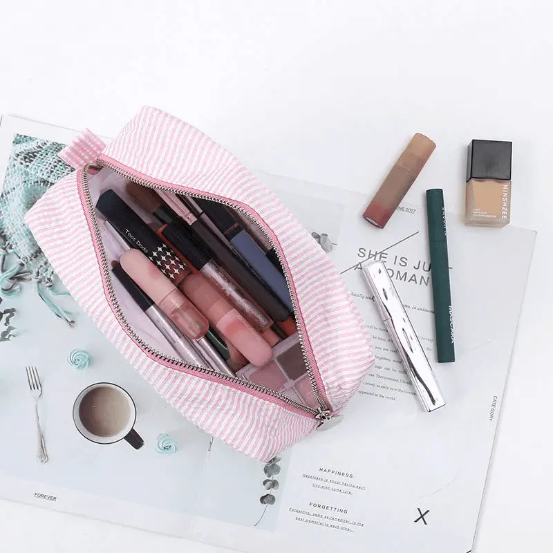 Vibrant striped cosmetic bag angled view - Metal zipper quality for custom manufacturing