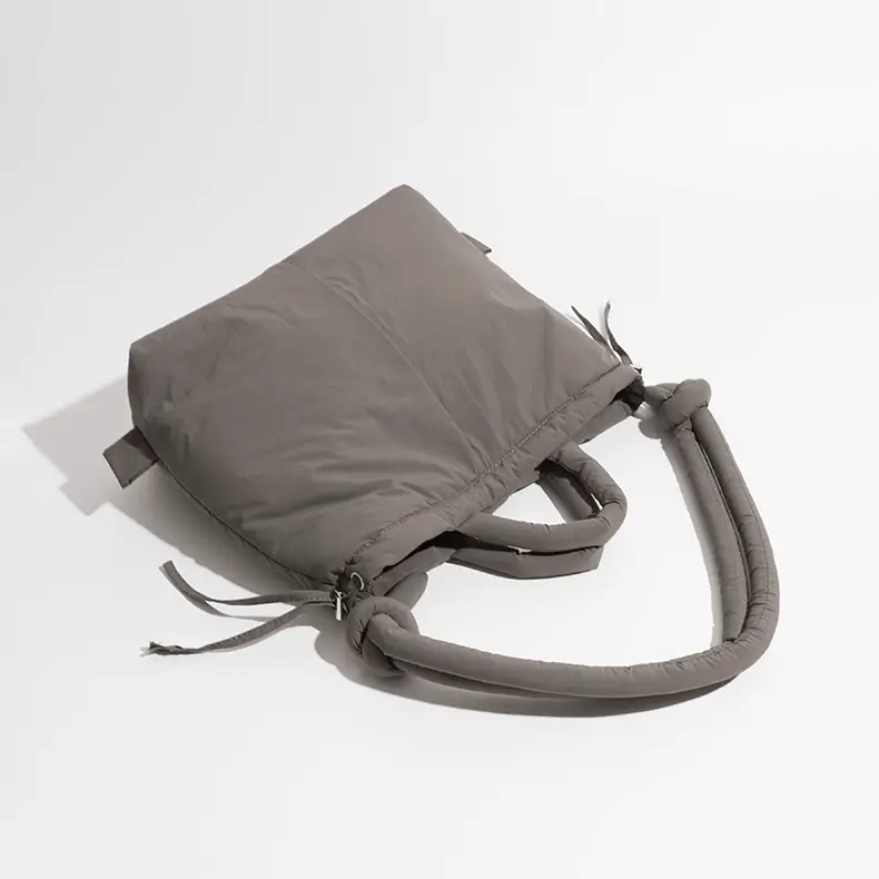 Padded shoulder tote angled view - Custom manufacturing quality for wholesale accessories showing knot detail