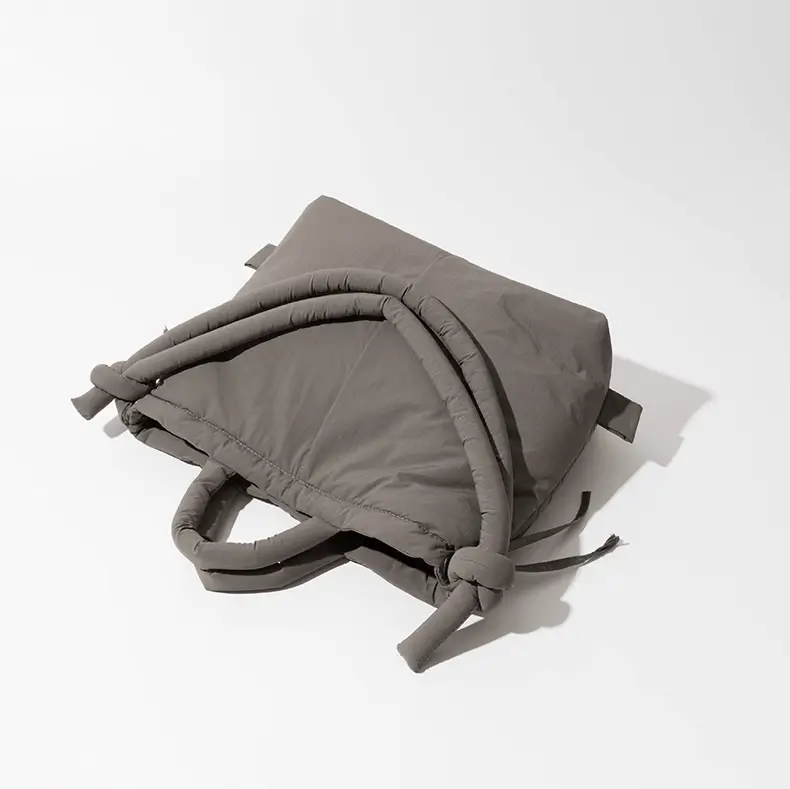 Padded shoulder tote side view - Manufacturing capacity for OEM orders showing relaxed structure